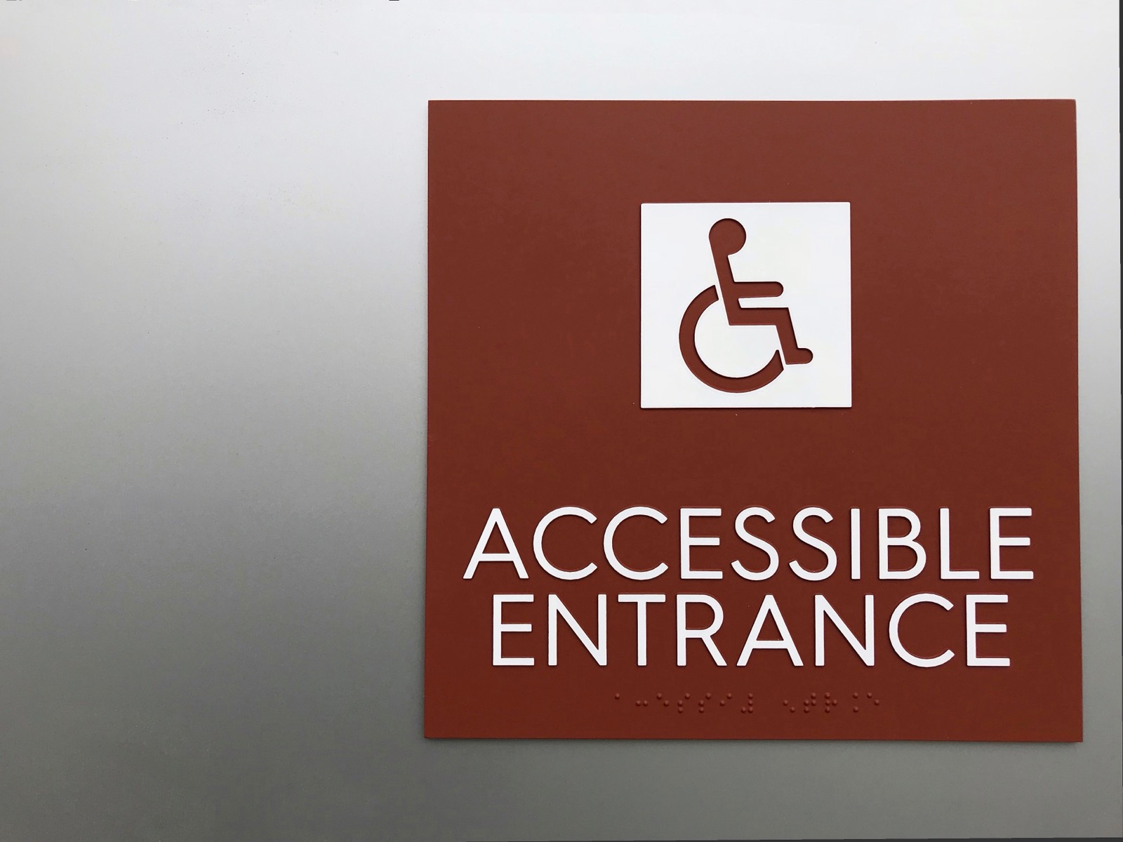 ADA accessible entrance sign with braille