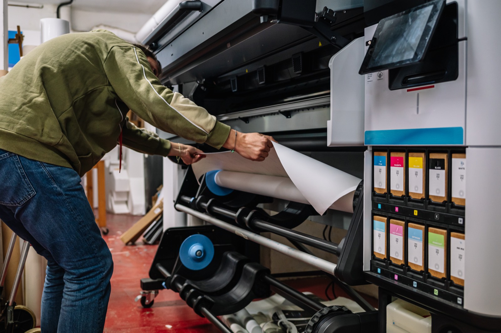 IPG press operator loading a wide-format banner
